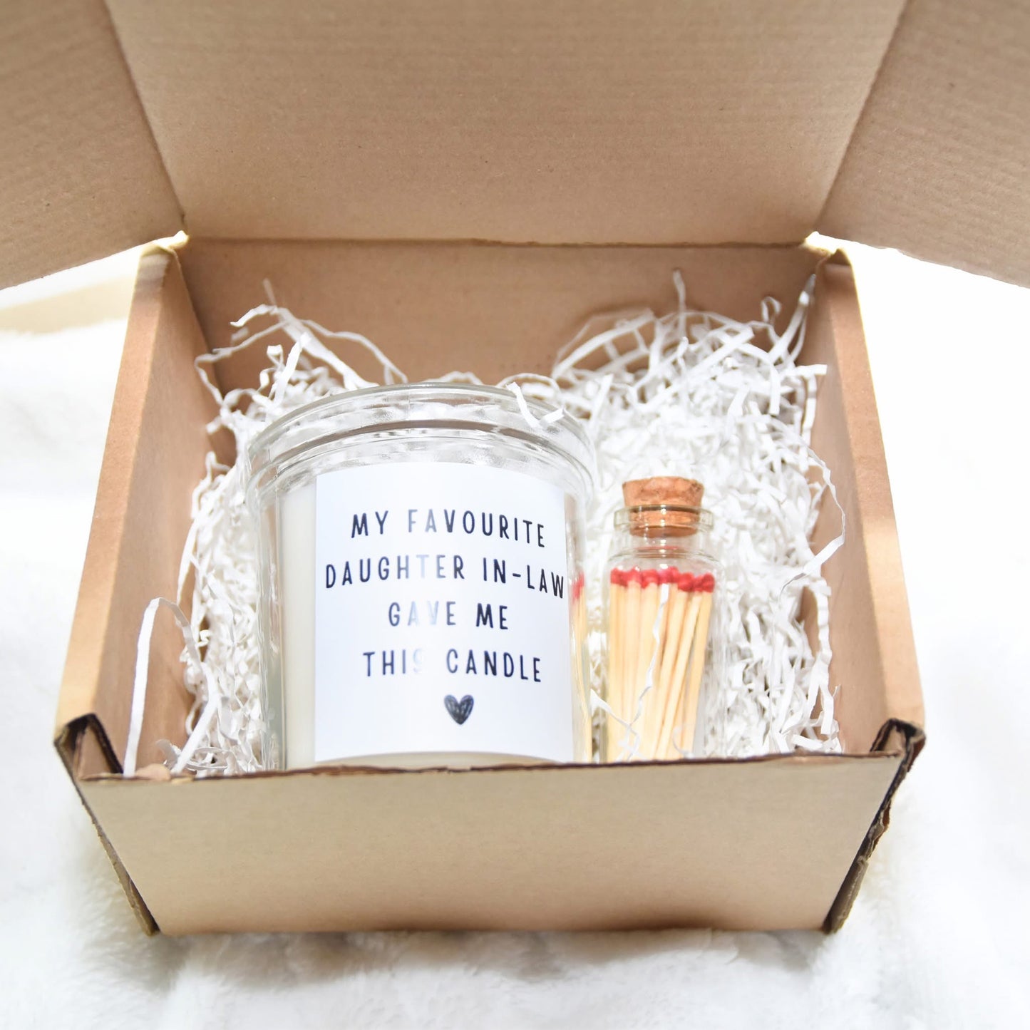 Candle with gift box and matches.