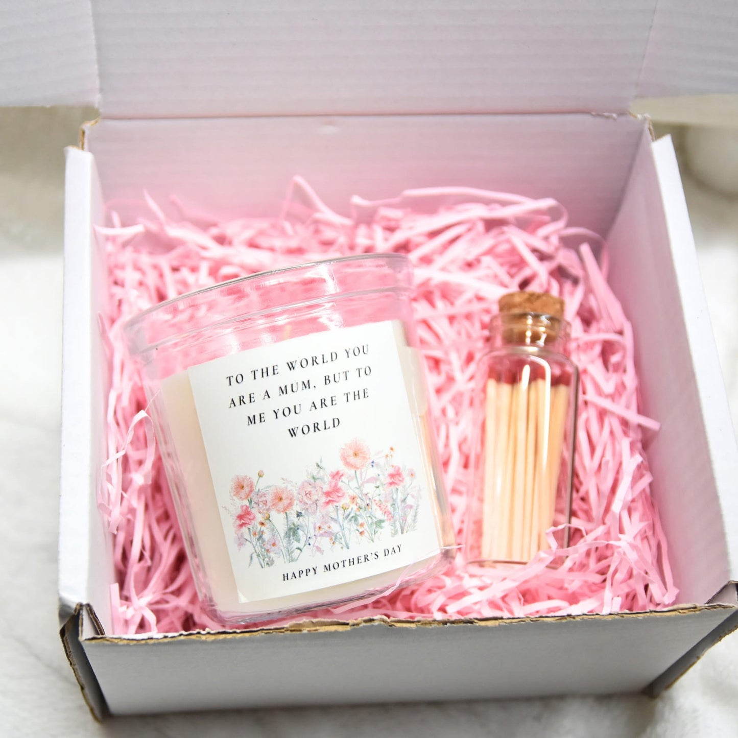 Candle with gift box and matches.
